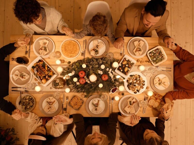 top view of a family praying before christmas dinner