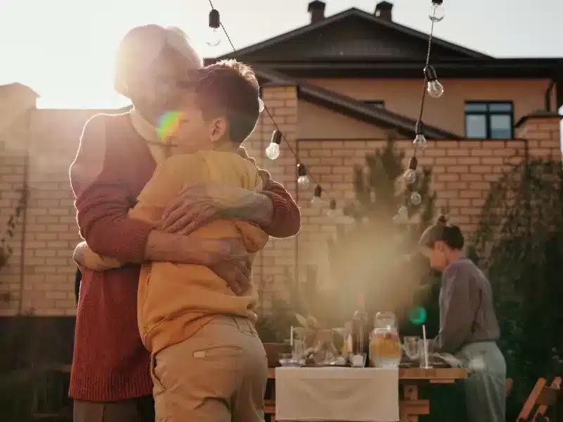elderly woman hugging a boy