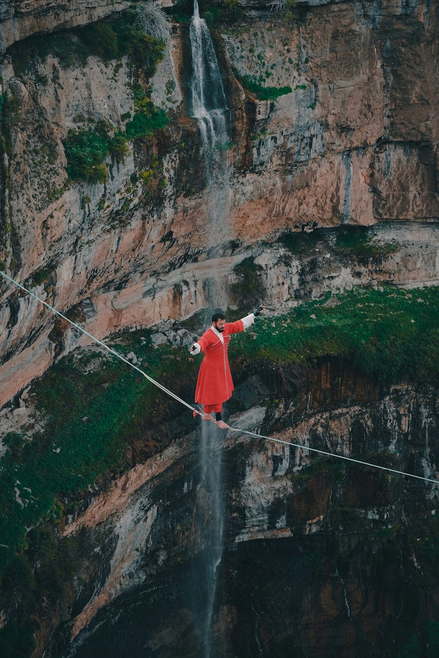 drone shot of a man walking on rope